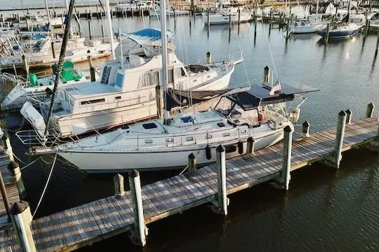 Slide: The Image of Sailboat Caliber 40LRC 1999 docked at marina with other boats. - 1