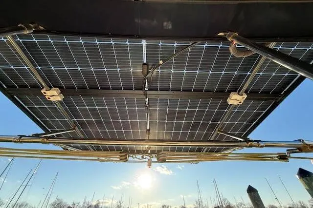 Slide: The Image of Solar panels on a 1999 Caliber 40LRC sailboat, harnessing sunlight for energy efficiency. - 10