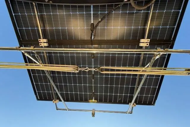 Slide: The Image of Solar panels mounted on a Caliber 40LRC, 1999 model, against a clear blue sky. - 11