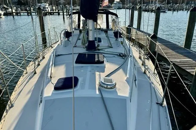 Slide: The Image of 1999 Caliber 40LRC sailboat docked at a marina, showcasing deck and rigging. - 16