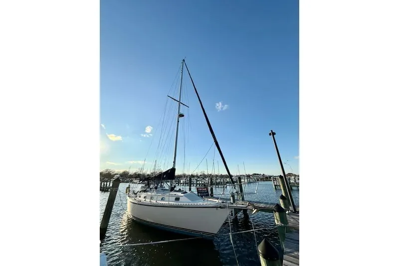 Slide: The Image of Sailboat docked at marina, 1999 Caliber 40LRC under clear blue sky. - 17