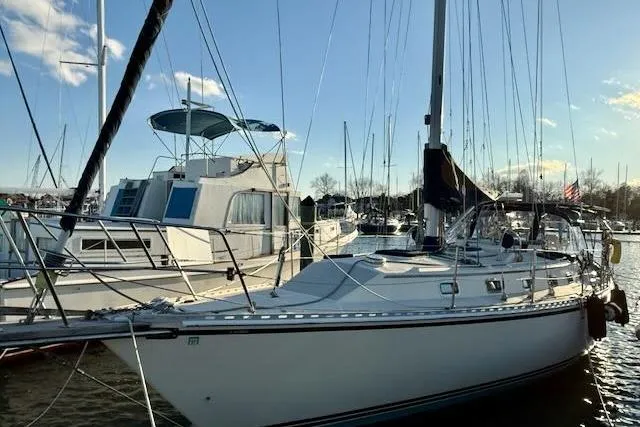 Slide: The Image of 1999 Caliber 40LRC sailboat docked at marina under clear blue sky. - 19