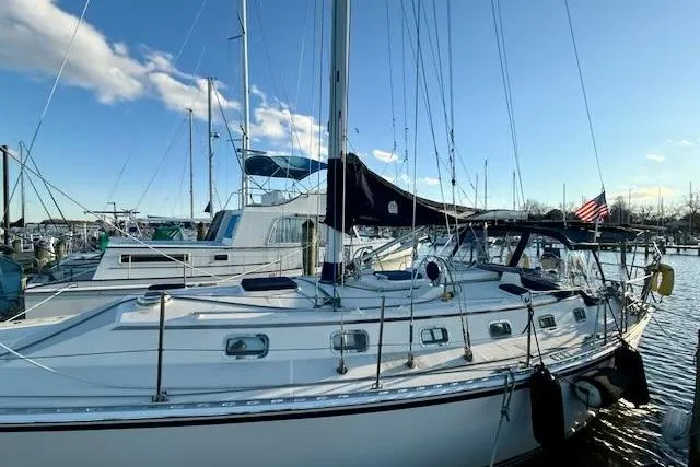 Slide: The Image of 1999 Caliber 40LRC sailboat docked in marina under clear blue sky. - 20