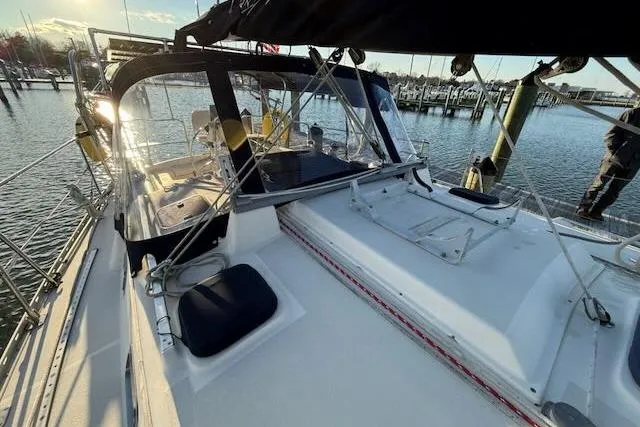 Slide: The Image of Sailboat Caliber 40LRC 1999 docked at marina, featuring spacious deck and cockpit. - 26