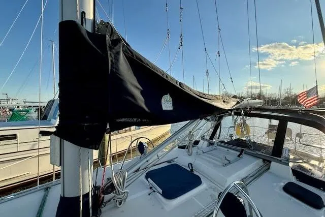 Slide: The Image of Sailboat deck view of 1999 Caliber 40LRC, docked with clear sky and American flag. - 3