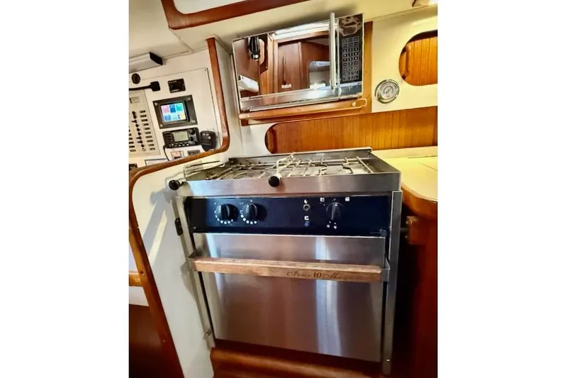 Slide: The Image of 1999 Caliber 40LRC yacht kitchen with stove, microwave, and control panel. - 32