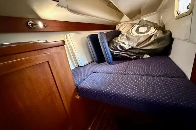 Slide: The Image of Cozy cabin interior of 1999 Caliber 40LRC sailboat with blue cushions. - 34