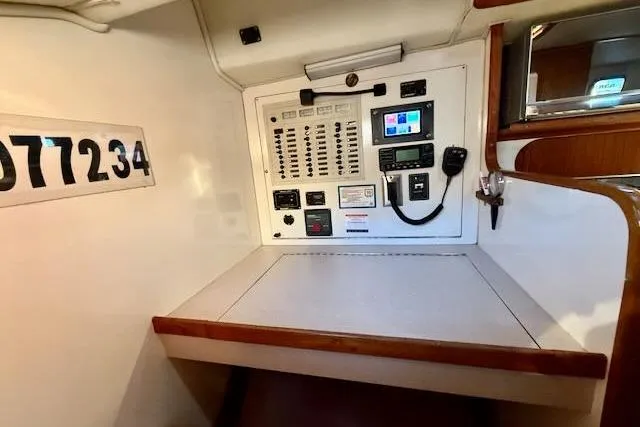 Slide: The Image of Electrical control panel inside 1999 Caliber 40LRC yacht, featuring switches and communication equipment. - 36