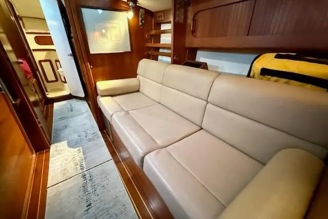 Slide: The Image of Interior of 1999 Caliber 40LRC yacht with beige leather sofa and wooden accents. - 38