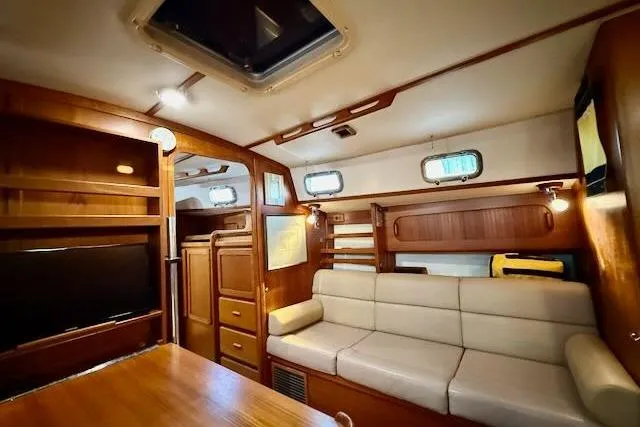 Slide: The Image of Interior of 1999 Caliber 40LRC yacht with wood finish and beige seating. - 40