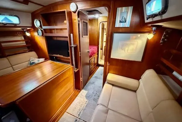 Slide: The Image of Luxurious 1999 Caliber 40LRC yacht interior with wood finish and cozy seating area. - 41