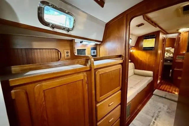 Slide: The Image of Interior of 1999 Caliber 40LRC yacht with wooden cabinetry and cozy seating area. - 45