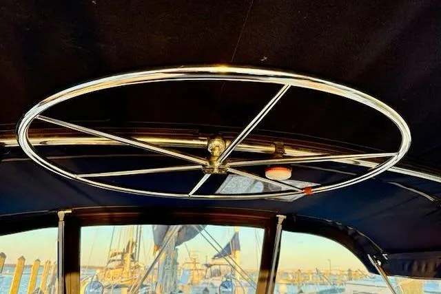 Slide: The Image of Interior view of a 1999 Caliber 40LRC sailboat with a metal steering wheel. - 49