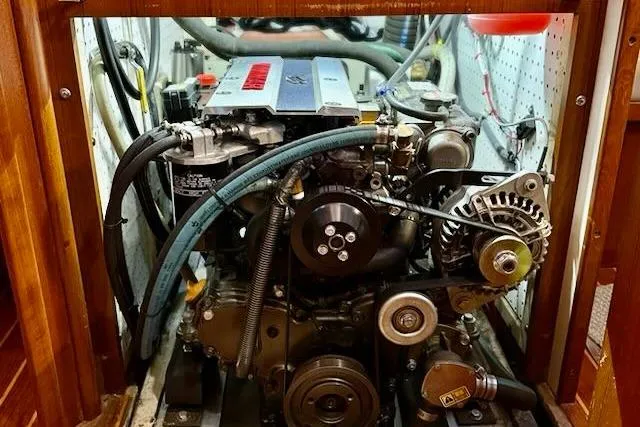 Slide: The Image of Engine compartment of a 1999 Caliber 40LRC sailboat, showcasing mechanical components and wiring. - 51