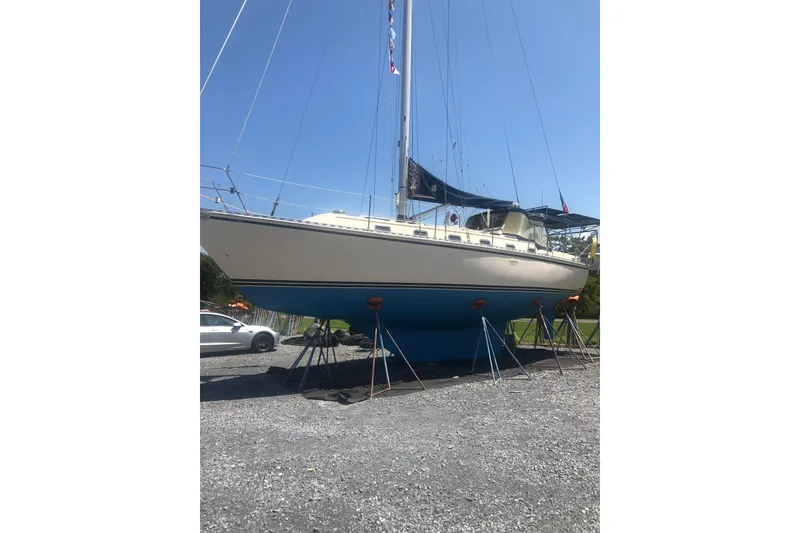 Slide: The Image of 1999 Caliber 40LRC sailboat on stands, blue hull, sunny day. - 56