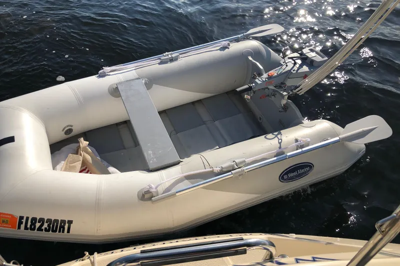Slide: The Image of Inflatable dinghy by West Marine on water, near a 1999 Caliber 40LRC sailboat. - 58