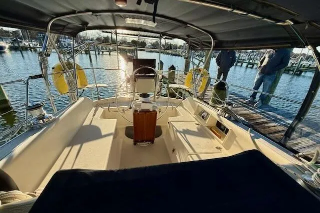 Slide: The Image of 1999 Caliber 40LRC sailboat cockpit with steering wheel, docked at marina. - 6