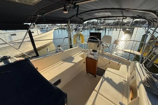 Slide: The Image of 1999 Caliber 40LRC sailboat cockpit with steering wheel, docked at marina. - 7