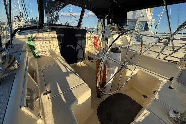 Slide: The Image of Cockpit of 1999 Caliber 40LRC sailboat with steering wheel and navigation equipment. - 8
