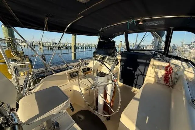 Slide: The Image of Cockpit of 1999 Caliber 40LRC sailboat with steering wheel and navigation equipment. - 9