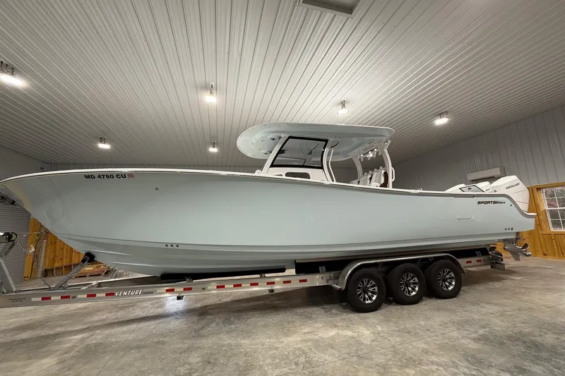 The Image of 2023 Sportsman Open 352 Center Console boat on trailer in indoor storage. - 0