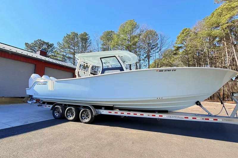 Slide: The Image of 2023 Sportsman Open 352 Center Console boat on trailer, parked outdoors. - 11