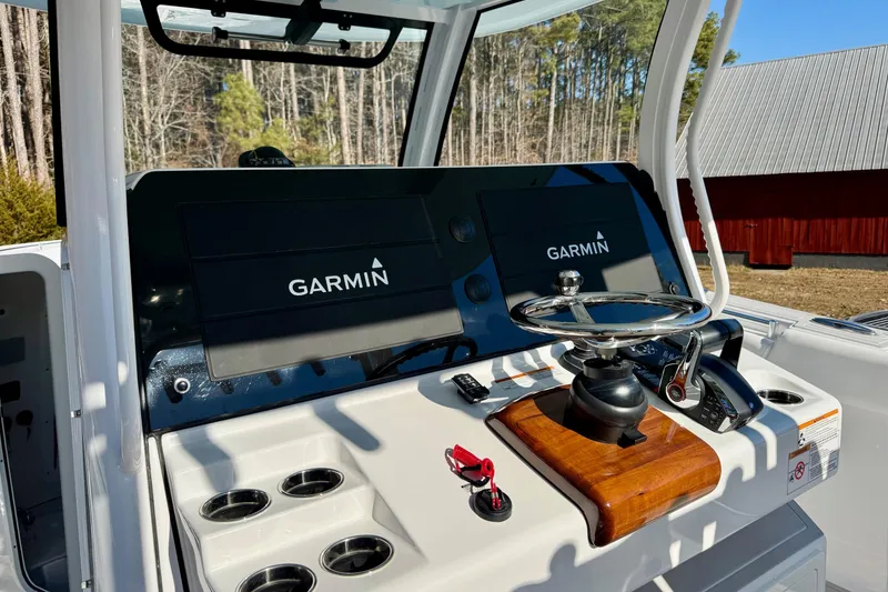 Slide: The Image of 2023 Sportsman Open 352 Center Console with Garmin displays and steering wheel. - 13