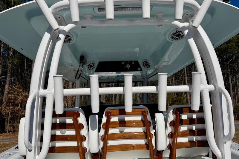 Slide: The Image of 2023 Sportsman Open 352 Center Console boat interior with rod holders and seating. - 15