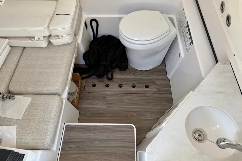 Slide: The Image of 2023 Sportsman Open 352 Center Console interior with toilet, seating, and sink. - 17