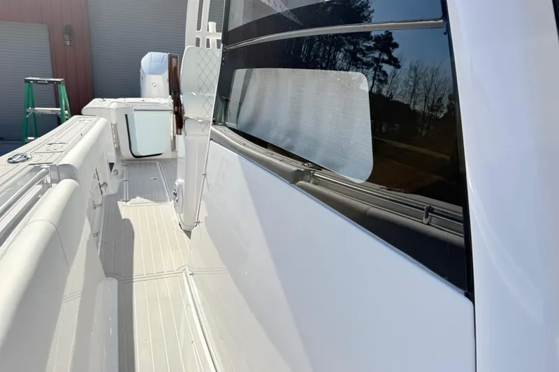 Slide: The Image of 2023 Sportsman Open 352 Center Console boat, sleek white deck and modern design. - 19