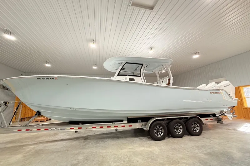 Slide: The Image of 2023 Sportsman Open 352 Center Console boat on trailer in indoor storage. - 2