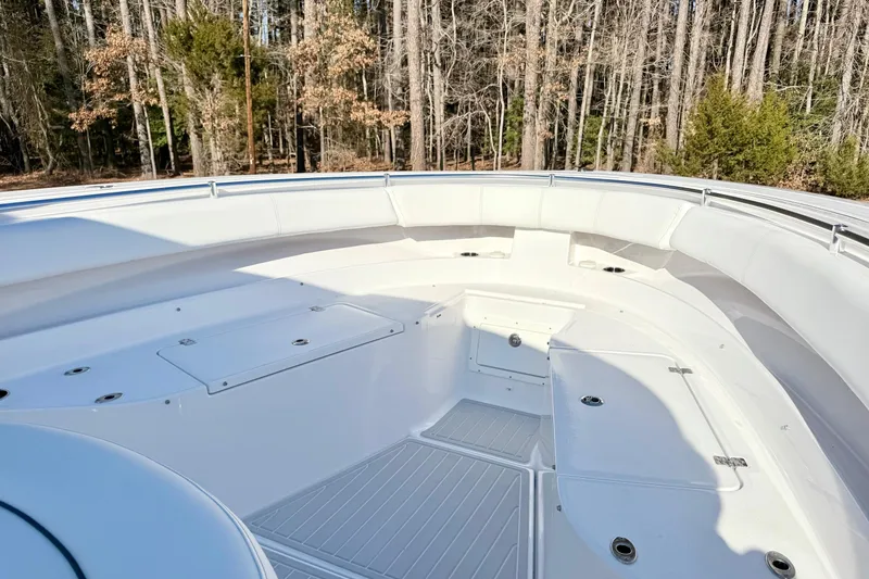Slide: The Image of 2023 Sportsman Open 352 Center Console boat interior with white seating and storage compartments. - 20