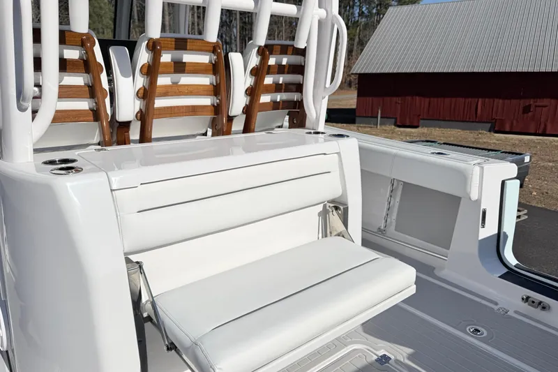 Slide: The Image of 2023 Sportsman Open 352 Center Console boat with white seating and wooden accents. - 24