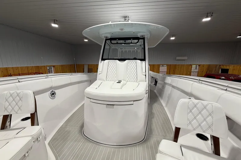 Slide: The Image of 2023 Sportsman Open 352 Center Console boat interior with white seating and modern design. - 3