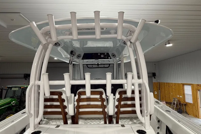 Slide: The Image of 2023 Sportsman Open 352 Center Console boat with rod holders in a garage. - 5