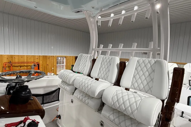 Slide: The Image of 2023 Sportsman Open 352 Center Console with luxurious seating and steering wheel in a showroom. - 7