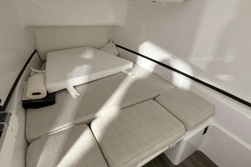 Slide: The Image of 2023 Sportsman Open 352 Center Console cabin interior with cushioned seating. - 9