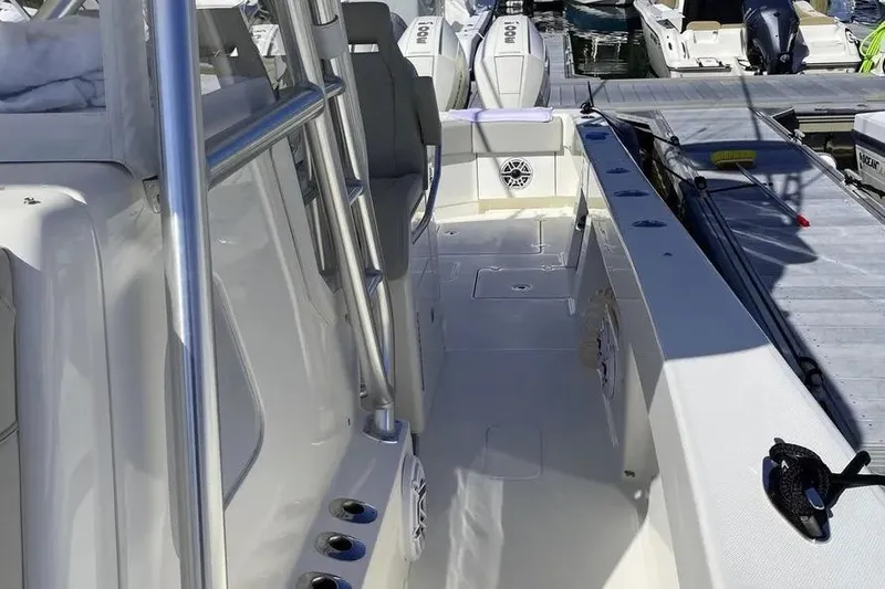 Slide: The Image of 2023 SeaVee 390Z boat deck with sleek design and modern features at a marina. - 11