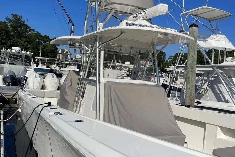 Slide: The Image of 2023 SeaVee 390Z boat docked, featuring Garmin equipment, surrounded by other vessels. - 12