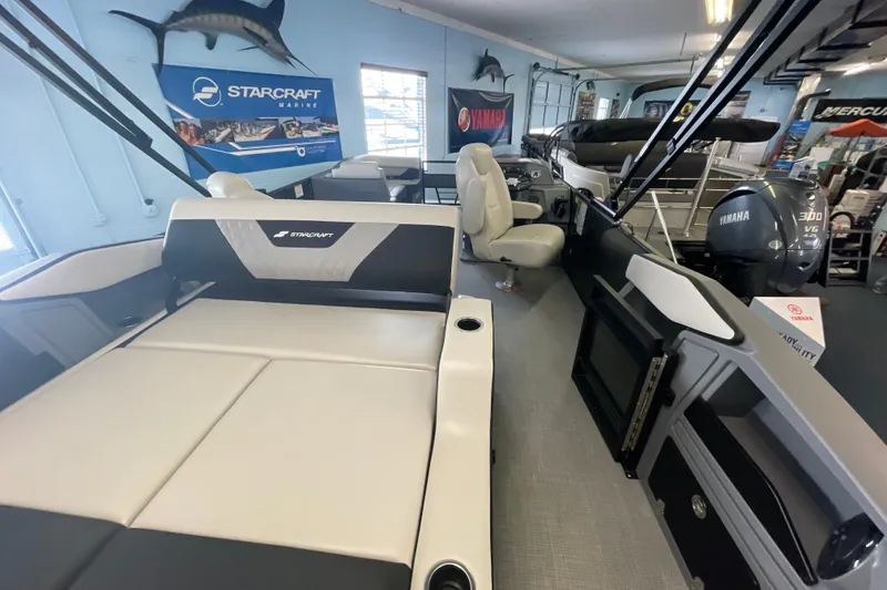 Slide: The Image of 2026 Starcraft VX 22 Q DH boat interior with seating and Yamaha engine display. - 3