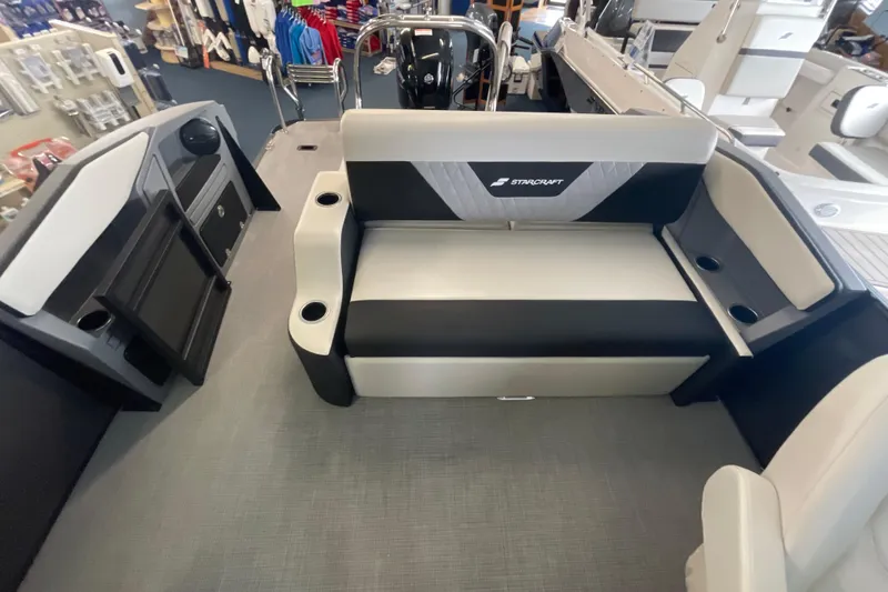 Slide: The Image of 2026 Starcraft VX 22 Q DH boat interior with seating and cup holders. - 4