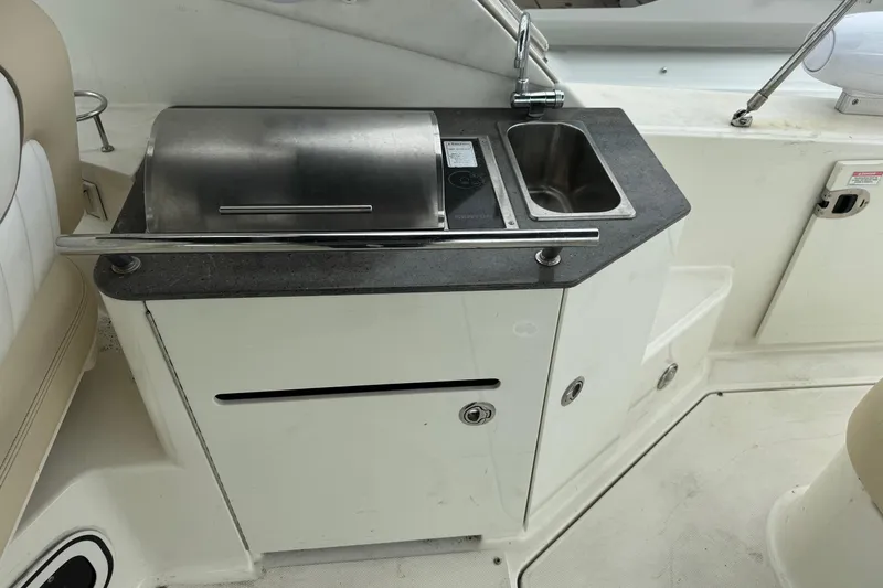 Slide: The Image of Outdoor kitchenette on a 2013 Sea Ray Sundancer 310 yacht with grill and sink. - 10