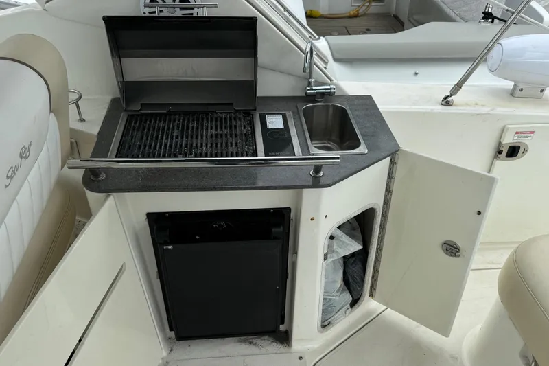 Slide: The Image of Outdoor kitchenette on a 2013 Sea Ray Sundancer 310 yacht with grill and sink. - 11