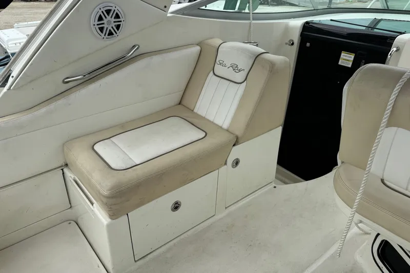 Slide: The Image of Interior seating of 2013 Sea Ray Sundancer 310 boat, featuring beige and white upholstery. - 15