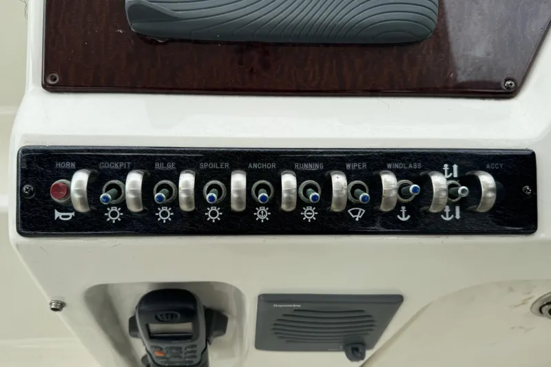 Slide: The Image of Control panel of a 2013 Sea Ray Sundancer 310 boat with labeled switches. - 22