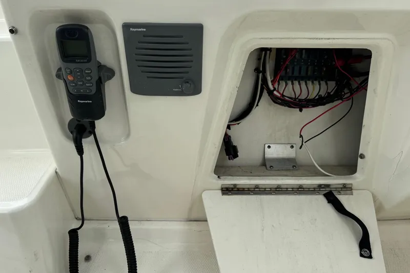 Slide: The Image of 2013 Sea Ray Sundancer 310 boat electronics panel with open wiring compartment. - 23