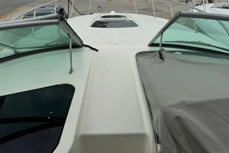 Slide: The Image of 2013 Sea Ray Sundancer 310 boat deck with windshield and cover. - 25