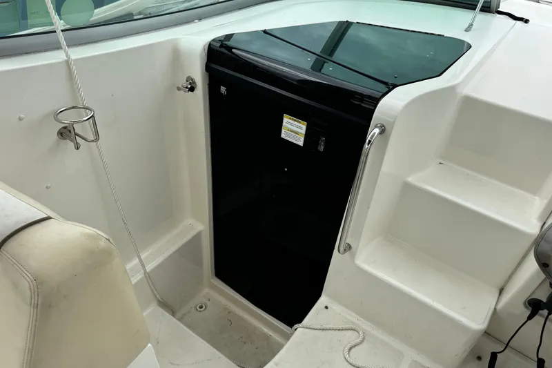 Slide: The Image of 2013 Sea Ray Sundancer 310 boat interior with steps and black door. - 29