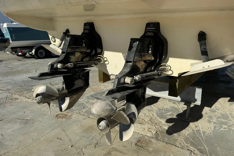 Slide: The Image of 2013 Sea Ray Sundancer 310 boat with dual MerCruiser outdrives on a concrete surface. - 3