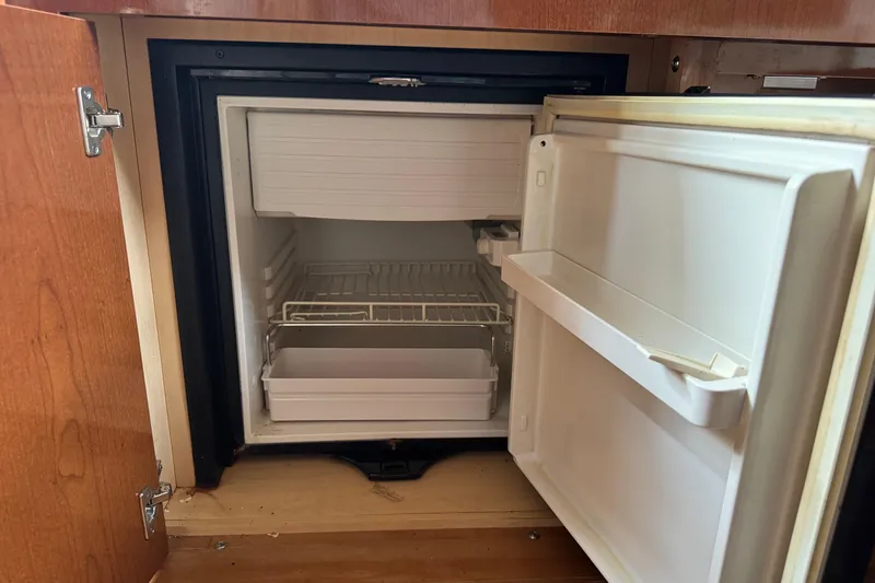 Slide: The Image of Open mini fridge inside 2013 Sea Ray Sundancer 310 boat cabin. - 35